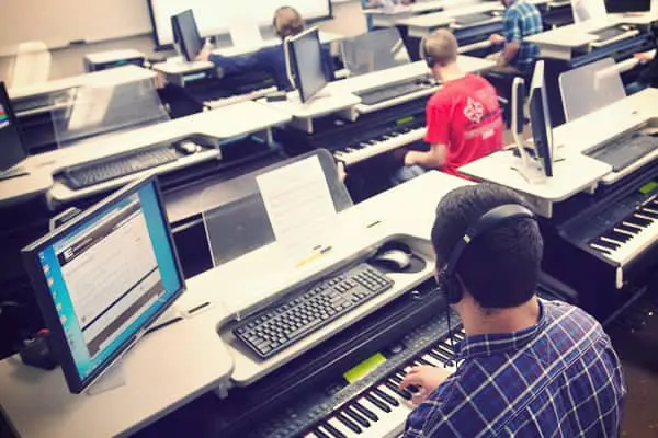 college classroom students learning piano skills